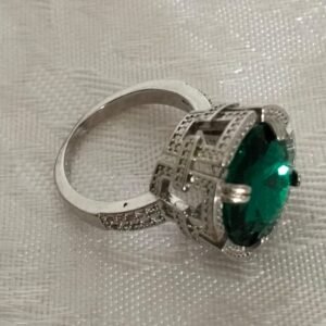 silver ring with green colored stone